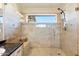 Walk-in shower with glass enclosure and built-in seat at 8894 E Sheena Dr, Scottsdale, AZ 85260