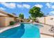 Inviting kidney-shaped pool with ample space for lounging at 8894 E Sheena Dr, Scottsdale, AZ 85260