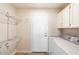 Bright laundry room with washer, dryer, and ample shelving for storage at 8894 E Sheena Dr, Scottsdale, AZ 85260