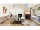 Bright living room features a fireplace and sliding glass doors leading to a patio at 8894 E Sheena Dr, Scottsdale, AZ 85260
