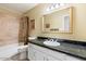 Guest bathroom with tub, toilet and granite countertop at 8894 E Sheena Dr, Scottsdale, AZ 85260