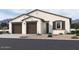 Two-story house with two car garage and desert landscaping at 2605 E Abe Truckle Ave, San Tan Valley, AZ 85140