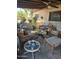 Relaxing covered patio furnished with wicker seating and a coffee table at 26415 S Recker Rd, Queen Creek, AZ 85142