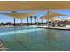 Resort-style pool with expansive deck and shade structures at 16006 W Electra Lane Ln, Surprise, AZ 85387