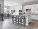 Modern kitchen with island, white cabinets, and breakfast bar at 15935 W Montana De Oro Dr, Surprise, AZ 85387