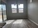 Light-filled dining area with wood-look flooring and large windows at 15935 W Montana De Oro Dr, Surprise, AZ 85387