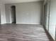 Living room with sliding glass doors and wood-look floors at 15935 W Montana De Oro Dr, Surprise, AZ 85387