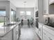 Modern kitchen with white cabinets, double oven, and breakfast bar at 15935 W Montana De Oro Dr, Surprise, AZ 85387