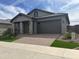 Modern one-story home with stone accents and landscaping at 15935 W Montana De Oro Dr, Surprise, AZ 85387