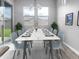 Bright dining room featuring a large marble table and access to the backyard at 15935 W Montana De Oro Dr, Surprise, AZ 85387