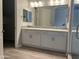 Double vanity bathroom with modern fixtures and gray tile at 15935 W Montana De Oro Dr, Surprise, AZ 85387