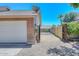 White garage door and side yard with gravel at 6221 W Sunnyside Dr, Glendale, AZ 85304