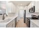 Modern kitchen with white cabinets, stainless steel appliances, and quartz countertops at 12641 N 18Th Pl, Phoenix, AZ 85022