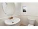 Elegant powder room with an oval mirror and modern fixtures at 12641 N 18Th Pl, Phoenix, AZ 85022