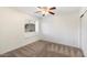 Bedroom featuring a window seat, ceiling fan, and carpeted floors at 12641 N 18Th Pl, Phoenix, AZ 85022