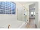 Bathroom with a soaking tub and glass shower at 12641 N 18Th Pl, Phoenix, AZ 85022