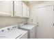 Laundry room with washer, dryer, and ample cabinet space at 12641 N 18Th Pl, Phoenix, AZ 85022