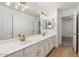 Modern bathroom with double vanity, white cabinets, and gold fixtures at 12641 N 18Th Pl, Phoenix, AZ 85022