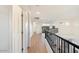Light and bright hallway with wood-look floors, offering views from a second story balcony at 12641 N 18Th Pl, Phoenix, AZ 85022