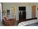 Bedroom with ensuite bathroom access, dresser, and comfortable armchair at 8500 E Southern Ave # 586, Mesa, AZ 85209