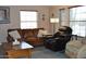 Living room with leather furniture, coffee table and large windows at 8500 E Southern Ave # 586, Mesa, AZ 85209