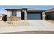 One-story home with a two-car garage and desert landscaping at 20879 N 223 Av Ave, Surprise, AZ 85387