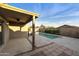 A covered patio overlooks a refreshing pool and backyard at 24911 W Dove Mesa Dr, Buckeye, AZ 85326