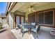 Covered patio with seating area, ceiling fan, and access to backyard at 16449 W Shangri La Rd, Surprise, AZ 85388