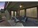 Relaxing covered patio with seating area and ceiling fan at 16449 W Shangri La Rd, Surprise, AZ 85388