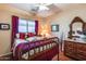 Bedroom with antique wooden bed and dresser at 16449 W Shangri La Rd, Surprise, AZ 85388