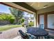 Patio with table and chairs, overlooking a grassy backyard and grill at 16449 W Shangri La Rd, Surprise, AZ 85388