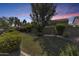 Landscaped backyard with lush greenery and a grassy area at 16449 W Shangri La Rd, Surprise, AZ 85388