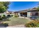 Landscaped backyard with covered patio and solar panels at 16449 W Shangri La Rd, Surprise, AZ 85388