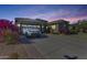 House exterior at dusk, showcasing landscaping and driveway at 16449 W Shangri La Rd, Surprise, AZ 85388