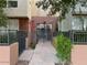 Well-maintained building entrance with gated access and landscaping at 706 E Washington St # 119, Phoenix, AZ 85034