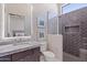 Spa-like bathroom with herringbone tile shower and modern vanity at 23625 N 63Rd Dr, Glendale, AZ 85310