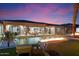 Evening view of the pool with fire feature and home at 23625 N 63Rd Dr, Glendale, AZ 85310