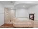 Elegant bathroom with a soaking tub, glass shower, and tiled flooring at 580 N Benson Ln, Chandler, AZ 85224