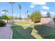 Spacious backyard with putting green, pool, and palm trees at 580 N Benson Ln, Chandler, AZ 85224