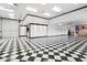 Spacious garage featuring a checkerboard floor and built-in cabinets at 580 N Benson Ln, Chandler, AZ 85224