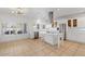 Bright white kitchen with island, stainless steel appliances, and tile floor at 580 N Benson Ln, Chandler, AZ 85224