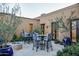 Outdoor patio with bistro seating and blue planters at 11179 E Honda Bow Rd, Scottsdale, AZ 85262