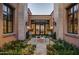 Ornate courtyard entry with fountain and landscaping, adding curb appeal to the home at 11179 E Honda Bow Rd, Scottsdale, AZ 85262