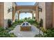 Elegant courtyard with fountain and lush landscaping, providing a tranquil outdoor space at 11179 E Honda Bow Rd, Scottsdale, AZ 85262