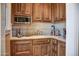 Small kitchen with wood cabinets and built-in appliances at 11179 E Honda Bow Rd, Scottsdale, AZ 85262