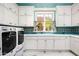 Bright laundry room with white cabinets and marble floors at 11179 E Honda Bow Rd, Scottsdale, AZ 85262