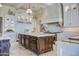 Island kitchen with custom cabinetry, granite countertops, and stainless steel appliances at 11179 E Honda Bow Rd, Scottsdale, AZ 85262