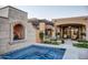 Hot tub and fireplace nestled in a beautifully landscaped backyard at 11179 E Honda Bow Rd, Scottsdale, AZ 85262