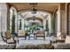 Relaxing covered patio with comfortable seating and arched entryways at 11179 E Honda Bow Rd, Scottsdale, AZ 85262