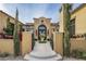 Elegant entryway with decorative gates and lush landscaping at 11179 E Honda Bow Rd, Scottsdale, AZ 85262